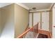 Upstairs hallway with a brown runner, wood floors, and multiple closet doors at 262 Sandhurst Ct, Suwanee, GA 30024