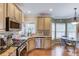 Well-equipped kitchen includes stainless appliances, granite counters, and breakfast area with a stylish light fixture at 262 Sandhurst Ct, Suwanee, GA 30024