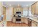 Gourmet kitchen features granite countertops, stainless appliances, and custom cabinets providing ample storage space at 262 Sandhurst Ct, Suwanee, GA 30024