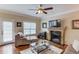 Inviting living room with hardwood floors, fireplace, and plenty of seating at 262 Sandhurst Ct, Suwanee, GA 30024