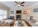 Cozy living room featuring hardwood floors, fireplace, and open concept design at 262 Sandhurst Ct, Suwanee, GA 30024
