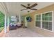 Covered patio with ceiling fan, outdoor television and brick pavers creating an inviting extension of the living space at 262 Sandhurst Ct, Suwanee, GA 30024