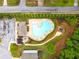 Aerial view of a community pool area with a playground, lounge area, and ample green space at 2887 Regal Park Ct, Duluth, GA 30096