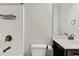 Compact bathroom featuring a shower, toilet, and vanity with a dark finish, maximizing space at 2887 Regal Park Ct, Duluth, GA 30096