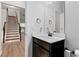 Elegant powder room with modern vanity, mirror, and stylish fixtures, conveniently located near the staircase at 2887 Regal Park Ct, Duluth, GA 30096