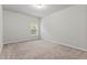 Bedroom featuring neutral carpet, paint, and a window providing natural light at 2887 Regal Park Ct, Duluth, GA 30096
