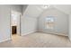 Well-lit bedroom with an angled ceiling, large window, and an ensuite bathroom at 2887 Regal Park Ct, Duluth, GA 30096