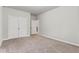 Neutral bedroom featuring a double door closet and access to the hallway at 2887 Regal Park Ct, Duluth, GA 30096