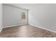 Cozy bedroom with neutral paint, wood floors, and a window letting in natural light at 2887 Regal Park Ct, Duluth, GA 30096