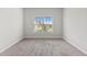 Neutral bedroom showcasing carpet, a window view, and ample natural light at 2887 Regal Park Ct, Duluth, GA 30096