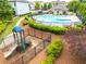 Community pool and fenced playground surrounded by lush greenery in residential neighborhood at 2887 Regal Park Ct, Duluth, GA 30096