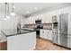 Bright kitchen with white cabinetry, black granite countertops, and stainless steel appliances at 2887 Regal Park Ct, Duluth, GA 30096