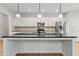 Well-equipped kitchen with stainless appliances, granite countertops, and pendant lighting over the large center island at 2887 Regal Park Ct, Duluth, GA 30096