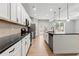 Contemporary kitchen featuring white cabinets, stainless appliances, and black granite island at 2887 Regal Park Ct, Duluth, GA 30096