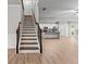 Open living space with hardwood floors, staircase, and kitchen with modern appliances at 2887 Regal Park Ct, Duluth, GA 30096