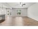 Bright and airy living room boasts wood floors, a ceiling fan, and access to the outdoor space through glass doors at 2887 Regal Park Ct, Duluth, GA 30096