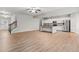 Spacious open-concept living area featuring hardwood floors, staircase, and modern kitchen at 2887 Regal Park Ct, Duluth, GA 30096