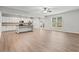 Open-concept living room and kitchen area with hardwood floors and plenty of natural light at 2887 Regal Park Ct, Duluth, GA 30096