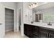Well-lit main bathroom with a walk-in shower, storage closet, and double vanity with white countertops at 2887 Regal Park Ct, Duluth, GA 30096
