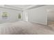 Large main bedroom suite featuring a tray ceiling, large windows, and a glimpse of the walk-in closet and ensuite at 2887 Regal Park Ct, Duluth, GA 30096
