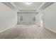 Expansive main bedroom with tray ceiling, two windows, and doorway to the ensuite bathroom at 2887 Regal Park Ct, Duluth, GA 30096