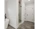 Bathroom featuring a glass enclosed shower and tub with wainscotting at 4002 Potter Way, Woodstock, GA 30188