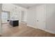 Open-concept kitchen with a black island, stainless appliances and hardwood floors at 4002 Potter Way, Woodstock, GA 30188