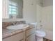 This bathroom features a tub and shower combo, a modern vanity and a window at 2045 Scarbrough Dr, Stone Mountain, GA 30088