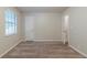 An empty bedroom includes neutral carpeting, trim and paint with a window and closet at 2045 Scarbrough Dr, Stone Mountain, GA 30088