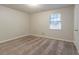 Carpeted bedroom featuring ample natural light from the window, with fresh neutral paint at 2045 Scarbrough Dr, Stone Mountain, GA 30088