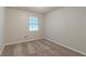 A bright bedroom with carpet, neutral walls and a large window providing natural light at 2045 Scarbrough Dr, Stone Mountain, GA 30088