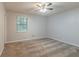 Bedroom with carpeting, a ceiling fan, a window, and fresh neutral paint at 2045 Scarbrough Dr, Stone Mountain, GA 30088