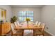 Staged dining room features a large table set for eight, with a nearby window and modern sideboard at 2045 Scarbrough Dr, Stone Mountain, GA 30088