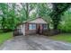 Attractive single-story brick home boasts a quaint, covered porch, plus a paved driveway at 2045 Scarbrough Dr, Stone Mountain, GA 30088