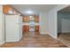 Bright kitchen with white appliances, ample cabinet space, and modern vinyl flooring at 2045 Scarbrough Dr, Stone Mountain, GA 30088