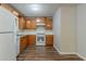 Updated kitchen with light wood cabinets, white appliances, and sleek vinyl floors at 2045 Scarbrough Dr, Stone Mountain, GA 30088
