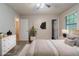 A modern, staged main bedroom featuring stylish furniture, window, and walk-in closet at 2045 Scarbrough Dr, Stone Mountain, GA 30088