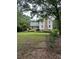 Charming two-story home featuring a covered front porch, brick chimney and large front lawn at 2377 Centerville Rosebud Rd, Loganville, GA 30052
