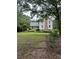 Charming two-story home featuring a covered front porch, brick chimney and large front lawn at 2377 Centerville Rosebud Rd, Loganville, GA 30052