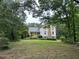 Charming two-story home featuring a covered front porch and well-manicured lawn at 2377 Centerville Rosebud Rd, Loganville, GA 30052