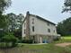 Rear of the house featuring a brick chimney and a door to access outside from the basement at 2377 Centerville Rosebud Rd, Loganville, GA 30052