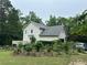 Rear exterior of the house with a well-maintained yard and attached garage at 2377 Centerville Rosebud Rd, Loganville, GA 30052