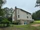 Rear of the house featuring a brick chimney and a door to access outside from the basement at 2377 Centerville Rosebud Rd, Loganville, GA 30052