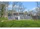 View of house from the backyard featuring a deck and grassy lawn at 2826 Ben Hill Rd, Atlanta, GA 30344