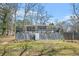 Backyard view of the house featuring a deck and grassy lawn at 2826 Ben Hill Rd, Atlanta, GA 30344