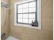 Updated bathroom featuring a window, shower fixtures, and neutral tile surround at 2826 Ben Hill Rd, Atlanta, GA 30344