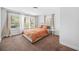 Cozy bedroom with carpet, a bed with an orange comforter, and bright natural light at 2826 Ben Hill Rd, Atlanta, GA 30344