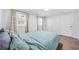 This bedroom has a blue comforter, neutral walls, and two closets for ample storage space at 2826 Ben Hill Rd, Atlanta, GA 30344