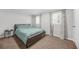 Bright bedroom featuring a bed with a blue comforter and windows for natural light at 2826 Ben Hill Rd, Atlanta, GA 30344
