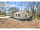 Charming single-Gathering home featuring light siding and dark window trim in a peaceful, wooded setting at 2826 Ben Hill Rd, Atlanta, GA 30344